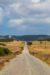 Fototapeta na wymiar A view along a road through the remote landscape, on the Karpas Peninsula in Cyprus