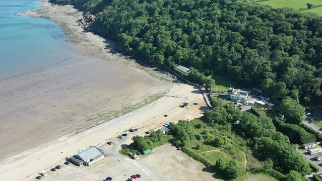 Oxwich Bay on the Gower peninsula in Swansea, UK, a long sweeping sandy bay with a shallow water line with easy access by road from Swansea attracts visitors from all over the UK
