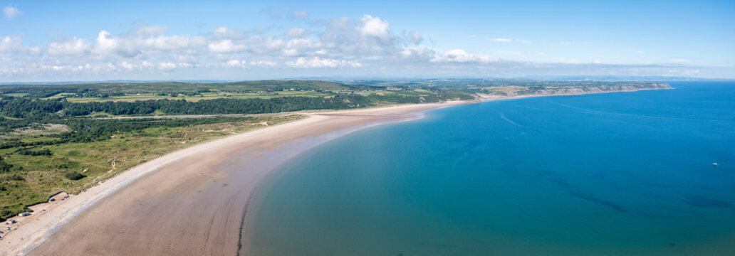 Oxwich Bay on the Gower peninsula in Swansea, UK, a long sweeping sandy bay with a shallow water line with easy access by road from Swansea attracts visitors from all over the UK