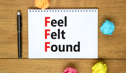 FFF feel felt found technique symbol. Concept words FFF feel felt found on white note on a beautiful wooden background. Metallic pen. Psychological FFF feel felt found technique concept. Copy space.