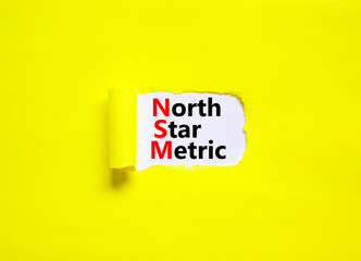 NSM north star metric symbol. Concept words NSM north star metric on white paper on a beautiful yellow background. Business and NSM north star metric concept. Copy space.