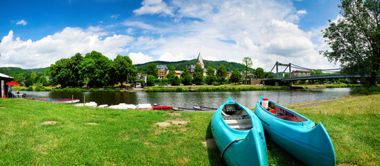 Nassau an der Lahn, Germany. View of the Lahn riverbank with paddle boats in the foreground.