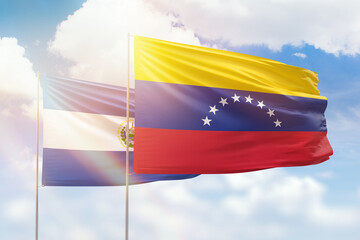 Sunny blue sky and flags of venezuela and el salvador