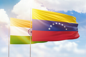 Sunny blue sky and flags of venezuela and india