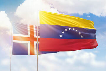 Sunny blue sky and flags of venezuela and iceland