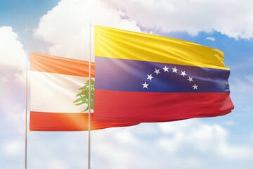 Sunny blue sky and flags of venezuela and lebanon
