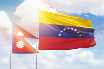 Sunny blue sky and flags of venezuela and nepal
