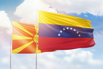 Sunny blue sky and flags of venezuela and north macedonia
