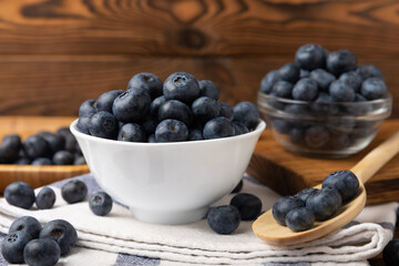 Blueberries in a bowl on a brown textured background. Ripe and fresh blueberries. vitamins. Health food. Juicy berry. Copy space. Place for text