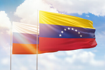Sunny blue sky and flags of venezuela and russia