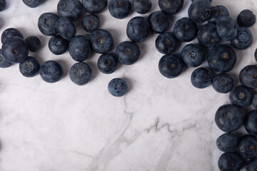 Blueberry. Ripe and fresh blueberries on a marble background. Vitamins. Healthy food. Juicy berry. Copy space. Place for text
