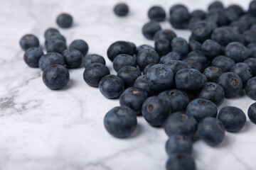 Blueberry. Ripe and fresh blueberries on a marble background. Vitamins. Healthy food. Juicy berry. Copy space. Place for text