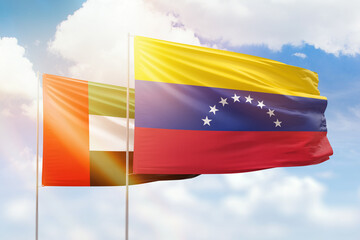 Sunny blue sky and flags of venezuela and uae