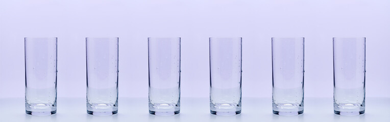 Empty glasses on a light lilac background, bar, restaurant, advertising