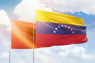 Sunny blue sky and flags of venezuela and albania