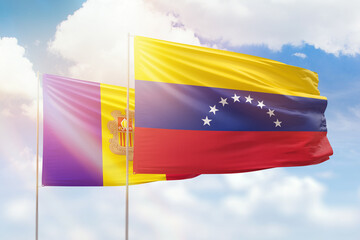 Sunny blue sky and flags of venezuela and andorra