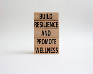 Build Resilience and Promote Wellness symbol. Wooden blocks with words Build Resilience and Promote Wellness. Beautiful white background. Build Resilience and Promote Wellness. Copy space