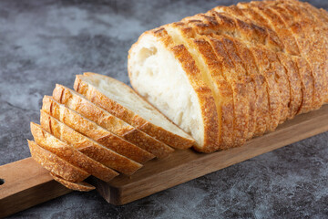 Fresh white loaf of bread on gray cement background. Top view - obrazy, fototapety, plakaty