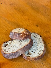 Three slices of wheat bread on a wood background