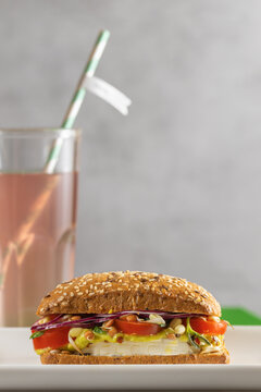 vegan diet burger with sesame seeds, microgreens, tofu cheese, tomato and avocado, copyspace