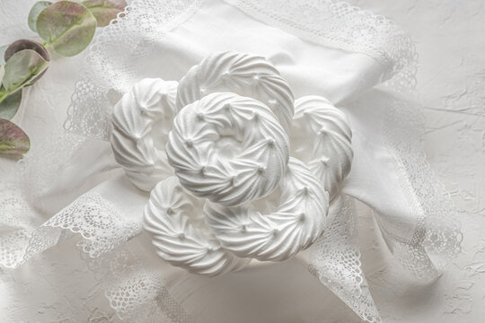 meringue dessert is white, on a white napkin, pastel colors