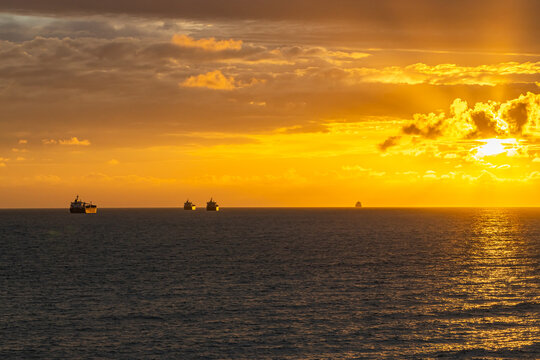 tankers with oil at sea going into a fiery sunset. Crimea May 2021