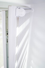 Close up mechanism of tnaninny roller blinds indoors. Duo window roller system day and night.