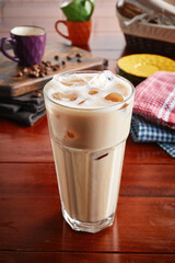 A glass of healthy fresh ICED MOCHA isolated on wooden background side view