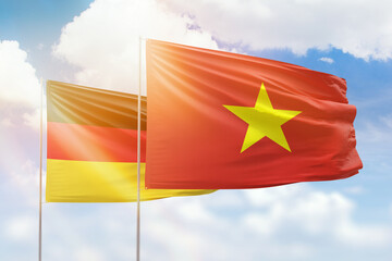 Sunny blue sky and flags of vietnam and germany - obrazy, fototapety, plakaty