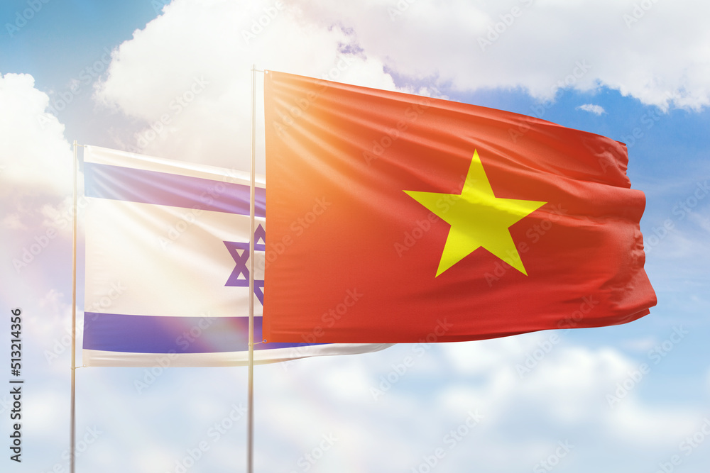 Wall mural sunny blue sky and flags of vietnam and israel