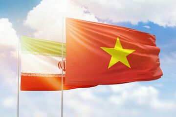 Sunny blue sky and flags of vietnam and iran