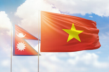 Sunny blue sky and flags of vietnam and nepal