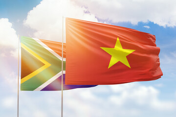 Sunny blue sky and flags of vietnam and south africa