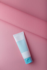 Cosmetics mockup. Collagen anti wrinkles creme tube, face skin care. Blank label, no brand template on pink background. Moisturizing care