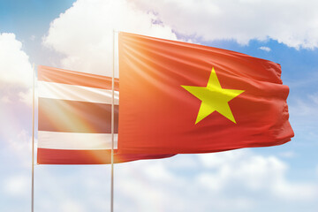 Sunny blue sky and flags of vietnam and thailand