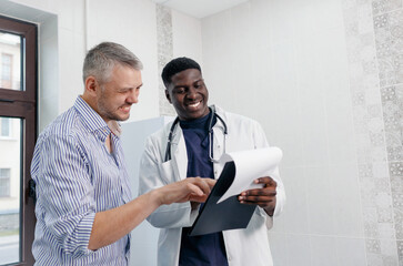 A young African-American doctor consultations with a patient in a medical office