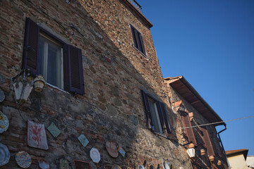 ceramic plates on a village street wall