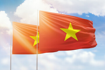 Sunny blue sky and flags of vietnam and vietnam