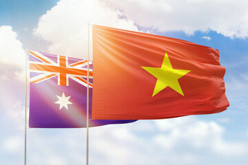 Sunny blue sky and flags of vietnam and australia