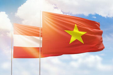 Sunny blue sky and flags of vietnam and austria