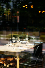 Glasses and dish on a wooden table in a indoor restaurant