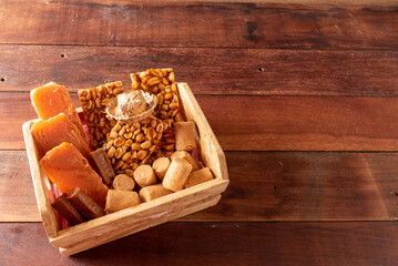 Obraz na płótnie Canvas Wooden table with typical Brazilian Festa Junina foods