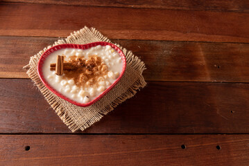 Wooden table with typical Brazilian Festa Junina foods. Canjica