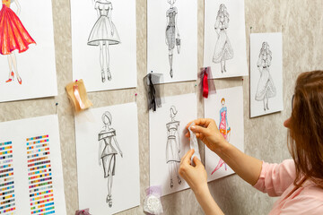 Dress design creates sketches. The fashion designer of women's fashion clothes develops a style....