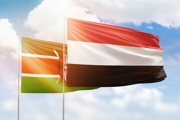 Sunny blue sky and flags of yemen and kenya