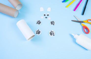 Festive easy DIY craft for children. Roll of toilet paper toy bear on a blue background. Creative decoration eco friendly, reuse, recycling, minimal waste free handmade concept