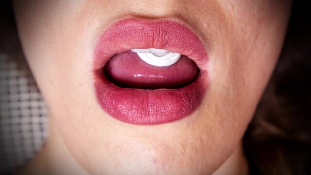A pill on a woman's tongue