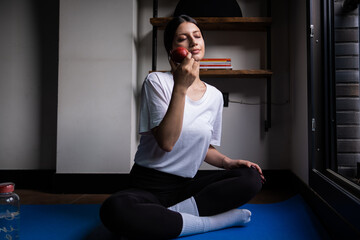 healthy lifestyle, woman doing yoga at home and eating apple, healthy lifestyle, home environment