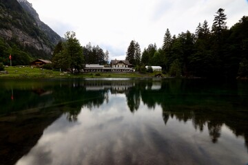 reflection in the water of a house at blausee bern Switzerland 