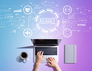 Insurance concept with person using a laptop computer